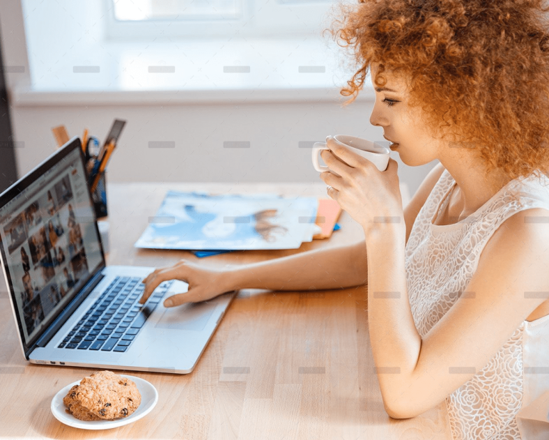 demo-attachment-493-woman-photographer-drinking-coffee-and-working-PJNBP6U